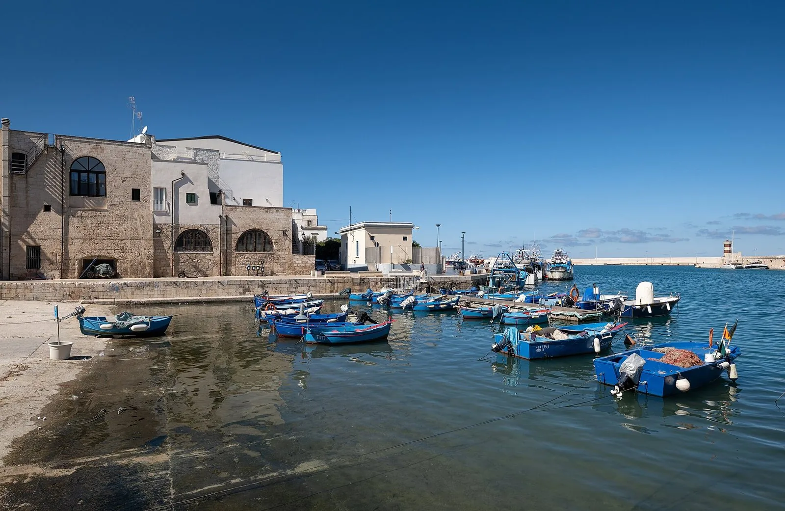 Il porto vecchio di Monopoli con le barche da pesca e le case bianche